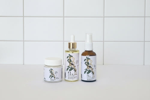 Three skincare products with 'Be You Skincare' branding on a light gray background